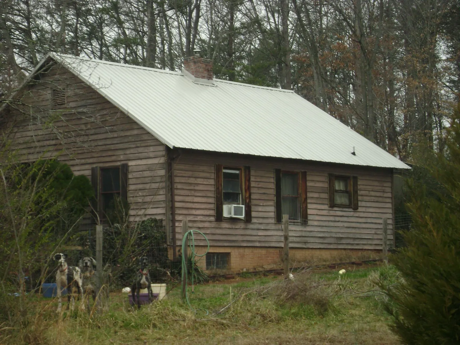 White metal roof on an old wood sided farmhouse, from a Metal Roof Installation job in Plantsville